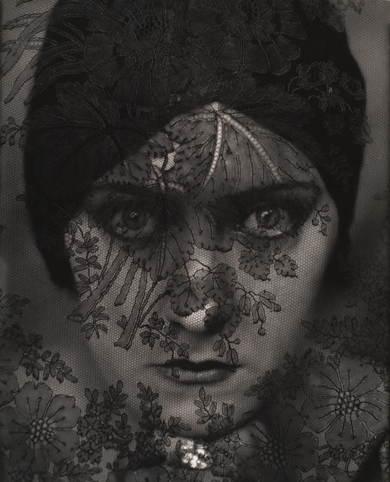 Edward Steichen, Gloria Swanson, 1924 — movie star photographed through lace veil, face emerging from darkness